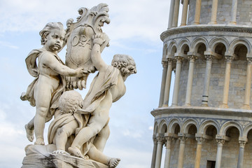 Fototapeta na wymiar sculptures and tower of Pisa in background