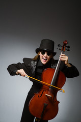 Woman playing classical cello in music concept