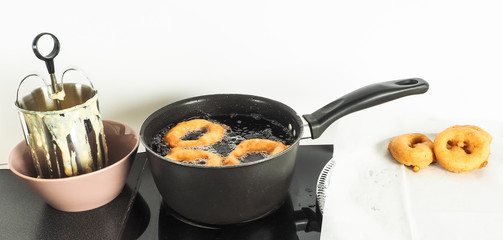 Donut maker in bowl, donuts boiling and donuts resting