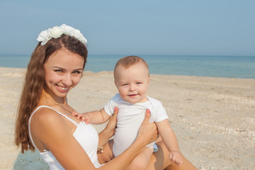 Mother and her son having fun on the beach