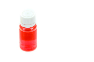 Small bottle of red liquid medicine isolated on white