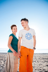 Young couple posing on the beach