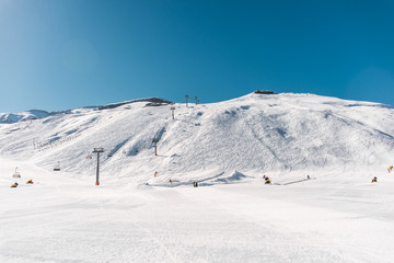 Fototapeta na wymiar Ski lifts durings bright winter day