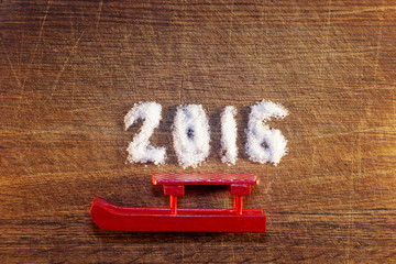 Happy new year 2016 written sugar on wooden background