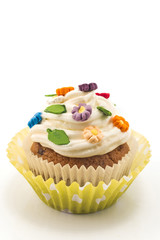 Cupcake decorating with flowers, isolated on white