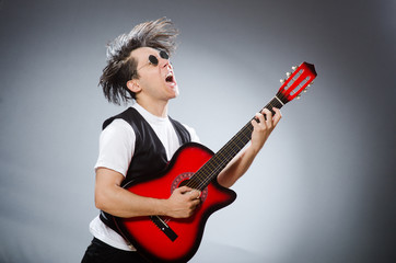 Funny guitar player in musical concept