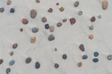 Fototapeta na wymiar Sand structure with colorful pebbles - Baltic coast