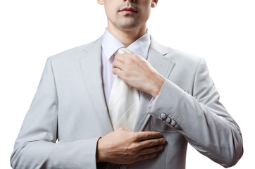 man in a tuxedo tie tightens