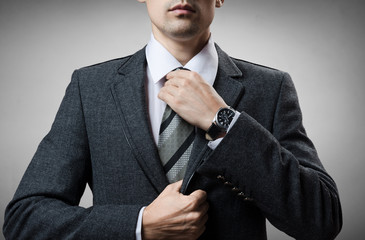 man in a tuxedo tie tightens