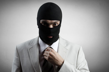 robber in a white tuxedo straightens tie