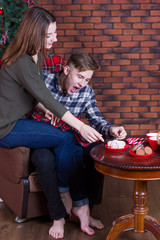 couple decorating a Christmas tree