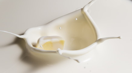 white chocolate falls in milk
