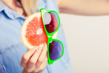 Summer girl holding grapefruit