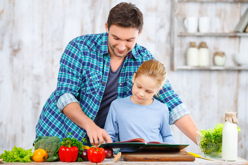 Happy father and daughter cooking together 