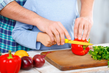 Happy father and daughter cooking together