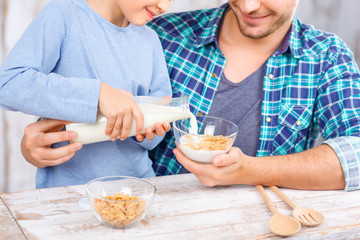 Positive father and daughter having breakfast 