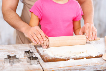 Happy father and daughter baking together 