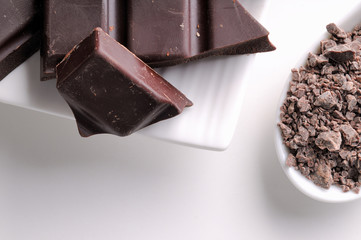 Chocolate chips and portions on containers close up top