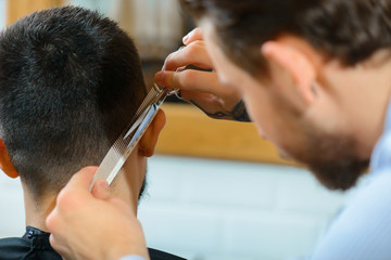 Professional barber  making haircut 