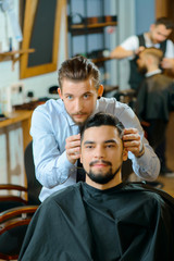 Pleasant client sitting in barber shop