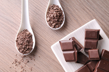 Portions and chocolate chips on white container on table top