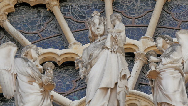 Sculpted images of angels on one of the walls in Notre Dame Cathedral. The cathedral is widely considered to be one of the finest examples of French Gothic architecture and it is among the largest  