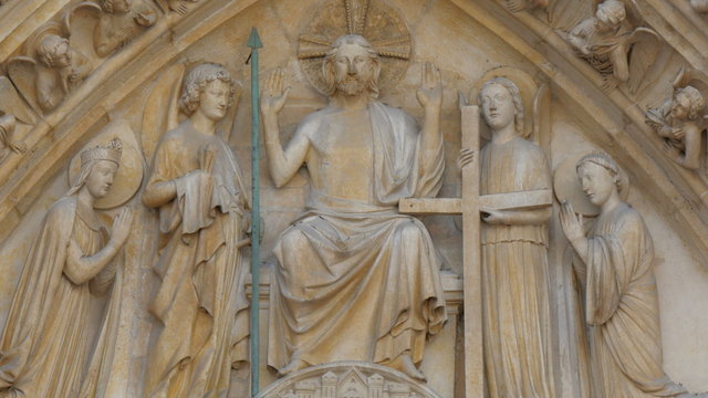 Carved image of Jesus and his apostles on the wall of the Notre Dame Cathedral in Paris