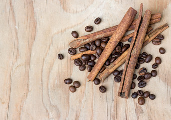 cinamon and coffee beans on wooden table.