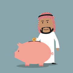 Arab businessman puts a coin into piggy bank