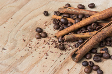 chocolate, cinamon and coffee beans on wooden table.