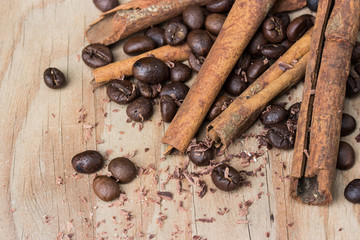 chocolate, cinamon and coffee beans on wooden table.