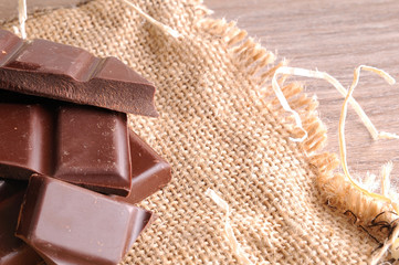 Heap of artisan portions chocolate on burlap elevated top view