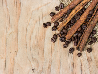 cinamon and coffee beans on wooden table.