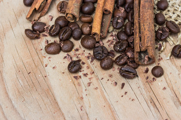 chocolate, cinamon and coffee beans on wooden table.