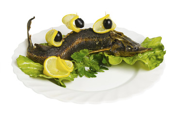 grilled sturgeon with lemon on the plate, isolated