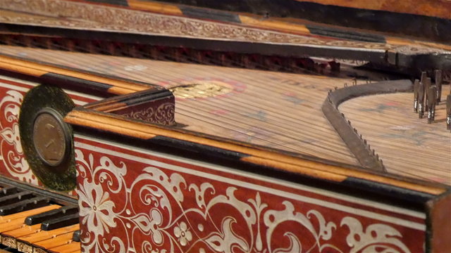 The strings on the back of the old piano. White strings that gives sounds to the piano