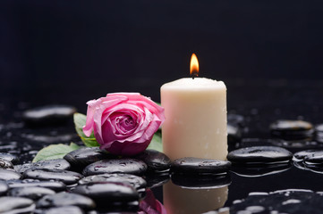 pink rose with white candle and therapy stones 