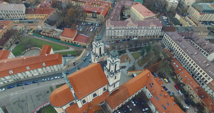 AERIAL. Smooth 360 flight around beautiful Church of St. Catherine (Kotrynos) in Vilnius old town, Lithuania. Panorama of Vilnius old town.