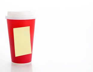 Coffee to go. Paper coffee cup with blank yellow sticky note