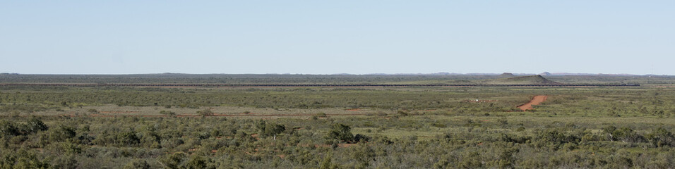 Fototapeta na wymiar Mile long iron ore train in the Hamersley ranges western australia.
