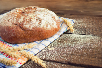Rye bread on a wooden background, space for text