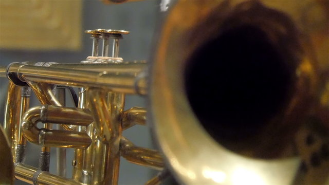 Closer look of the hole of the tuba. The instrument being displayed inside a room