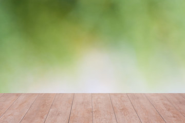 Wood table top on bokeh abstract green background - can be used for montage or display your products