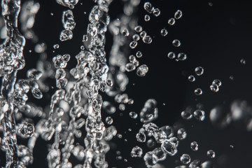 Levitation of water drops on black with copy space