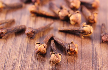 Closeup of cloves on wooden surface plank