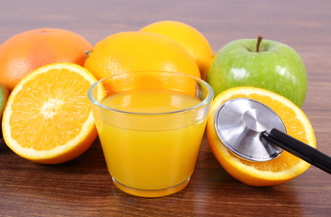 Stethoscope, fresh fruits and juice, healthy lifestyles and nutrition