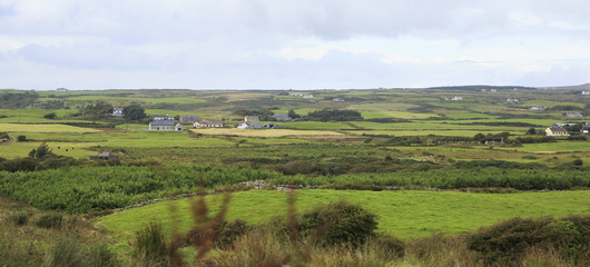 Fototapeta na wymiar Scenic view of Rural farmhouses among farmland.