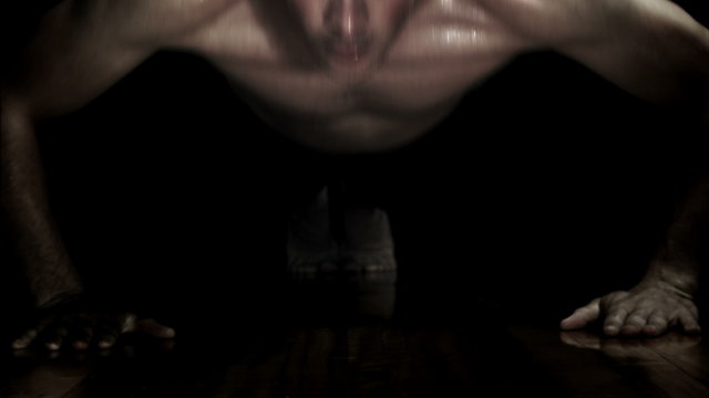 Video of a Man doing Push-ups isolated on a black Background