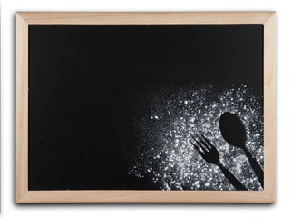 Imprint spoon made of flour on blackboard with wooden bamboo fra