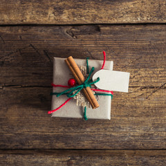 Christmas presents on a wooden background with candy cane, fir b